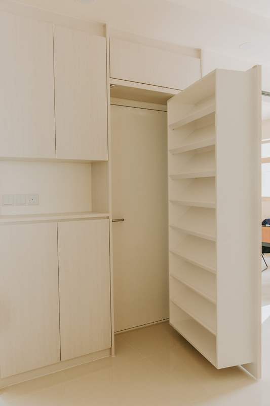 The same cabinet opened to reveal a pull-out shoe rack hidden behind the full-height door - HDB flat renovation with a glass-partitioned study, hidden shoe cabinet and navy kitchen (442BB) | Larry Contractors, HDB Licensed Renovation Contractor, Singapore