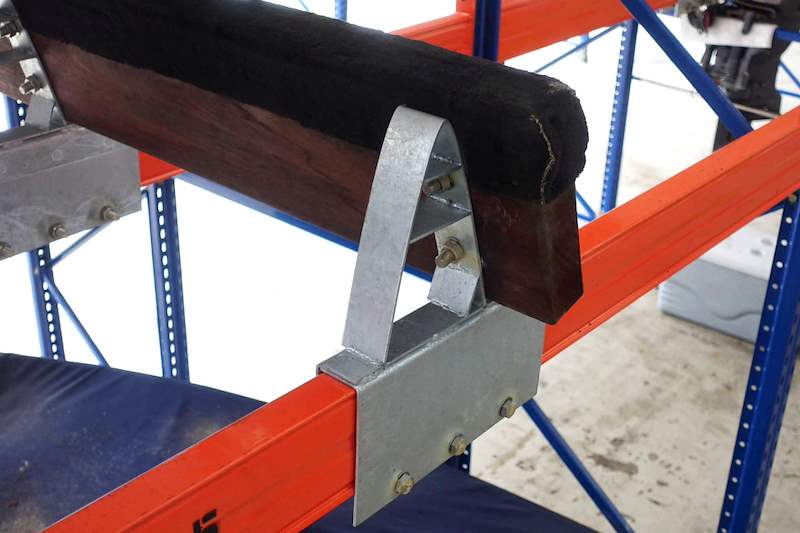 Close view of a galvanised bunk bracket bolted to an orange beam with a timber bunk on top - Heavy-duty storage racking for boats and jet skis (Sentosa) | Larry Contractors, HDB Licensed Renovation Contractor, Singapore
