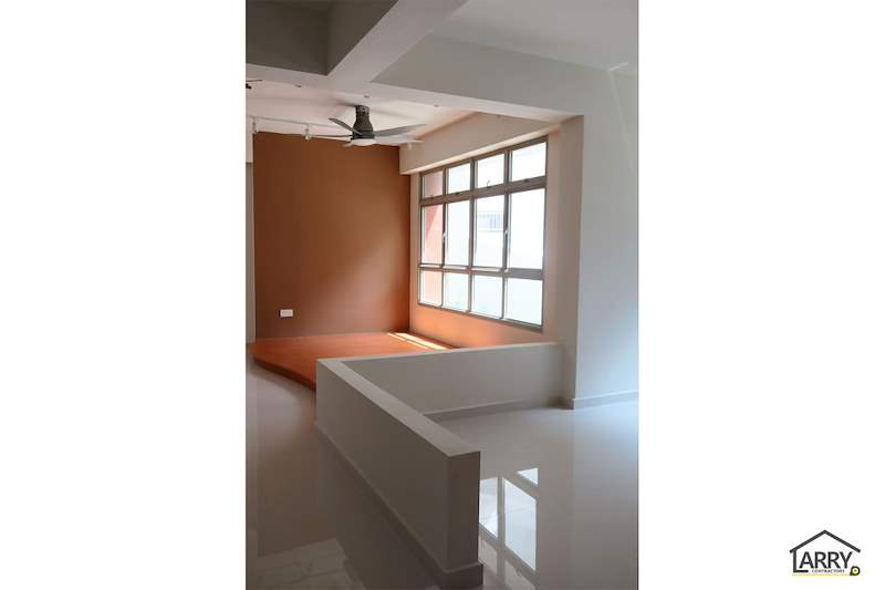 Living room platform with a low white parapet, seen from the hallway - HDB flat renovation with a platform bay window seat and blue kitchen (C20) | Larry Contractors, HDB Licensed Renovation Contractor, Singapore