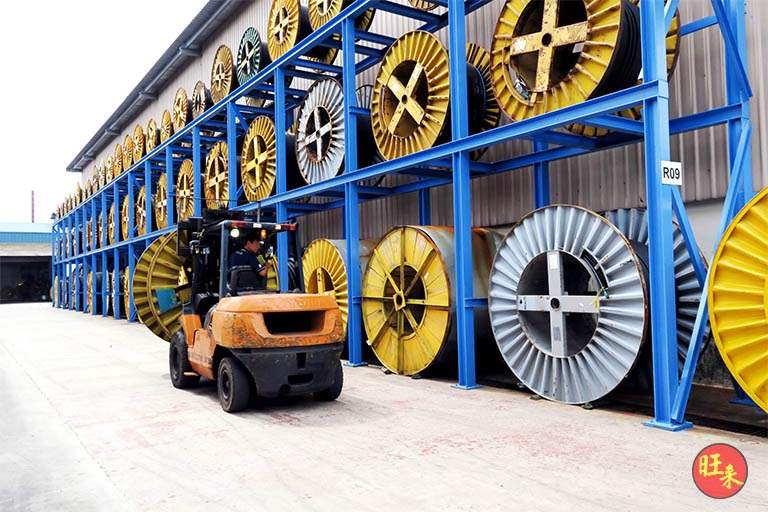 Forklift working in front of the loaded outdoor racking run - Heavy-duty cable drum racking in a cable yard (TSE) | Larry Contractors, HDB Licensed Renovation Contractor, Singapore