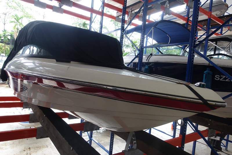 Covered speedboat resting on timber bunks on the upper tier of the steel rack - Heavy-duty storage racking for boats and jet skis (Sentosa) | Larry Contractors, HDB Licensed Renovation Contractor, Singapore