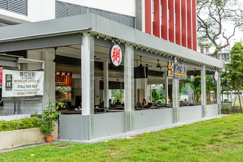 Finished covered dining extension with a flat roof, columns and stall signage beside the lawn - Covered dining extension for a coffee shop under an HDB block (140CD) | Larry Contractors, HDB Licensed Renovation Contractor, Singapore