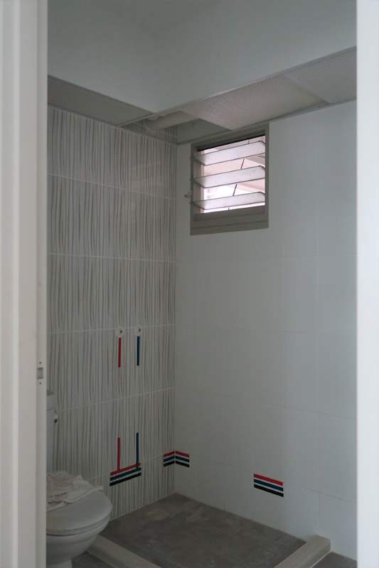 Before: the original bathroom with old wall tiles and a louvre window - HDB flat renovation with a platform bay window seat and blue kitchen (C20) | Larry Contractors, HDB Licensed Renovation Contractor, Singapore
