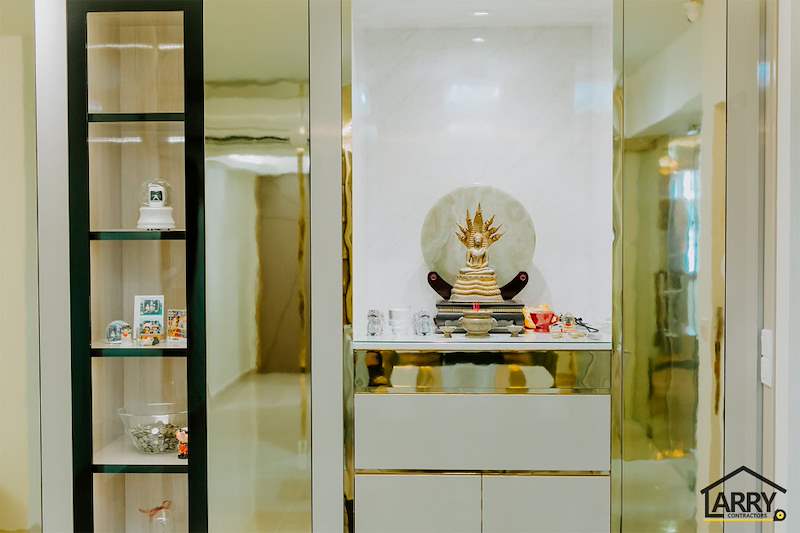 Lit altar niche with a marble-look back panel next to a black-framed glass display cabinet - HDB flat renovation in cream and mirror-trim laminate with a galley kitchen (C10) | Larry Contractors, HDB Licensed Renovation Contractor, Singapore