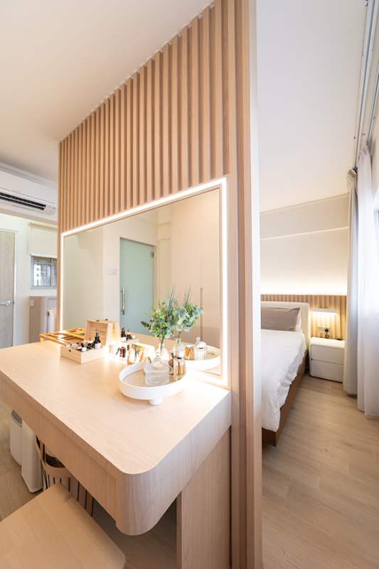 Bedroom dressing table with a lit mirror, timber-slat wall panel and the bed beyond - Full HDB maisonette renovation with a curved timber-slat island and lit staircase (140BB) | Larry Contractors, HDB Licensed Renovation Contractor, Singapore