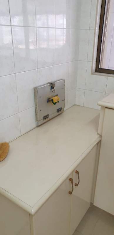 Before: the old service yard counter with white tiles and a cabinet under the window - HDB kitchen, bathroom and service yard renovation (140PP) | Larry Contractors, HDB Licensed Renovation Contractor, Singapore