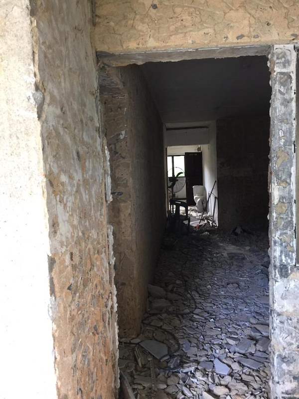 During works: a hacked doorway with exposed brick and rubble on the floor - HDB resale flat renovation with polished terrazzo floors, new kitchen and bathrooms (C04) | Larry Contractors, HDB Licensed Renovation Contractor, Singapore