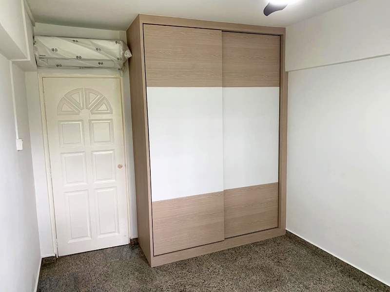 Bedroom with a sliding-door wardrobe beside a white panelled door, terrazzo floor - HDB resale flat renovation with polished terrazzo floors, new kitchen and bathrooms (C04) | Larry Contractors, HDB Licensed Renovation Contractor, Singapore