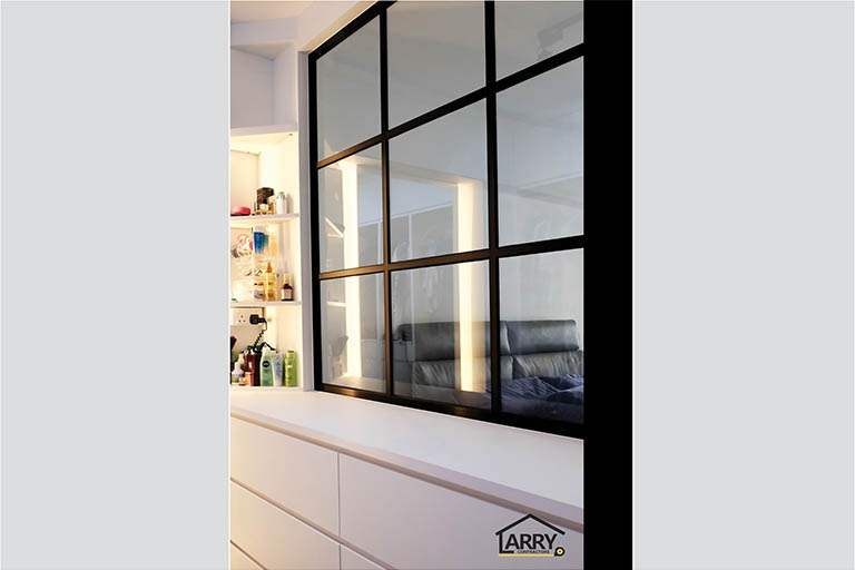 Close view of the black-framed glass partition above a white drawer unit in the bedroom - HDB flat renovation with a blue kitchen and a glass-walled walk-in wardrobe (C18) | Larry Contractors, HDB Licensed Renovation Contractor, Singapore