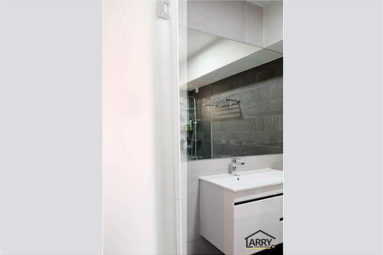 Bathroom with dark slate-look wall tiles, a rain shower and a white wall-hung basin - HDB flat renovation with a blue kitchen and a glass-walled walk-in wardrobe (C18) | Larry Contractors, HDB Licensed Renovation Contractor, Singapore