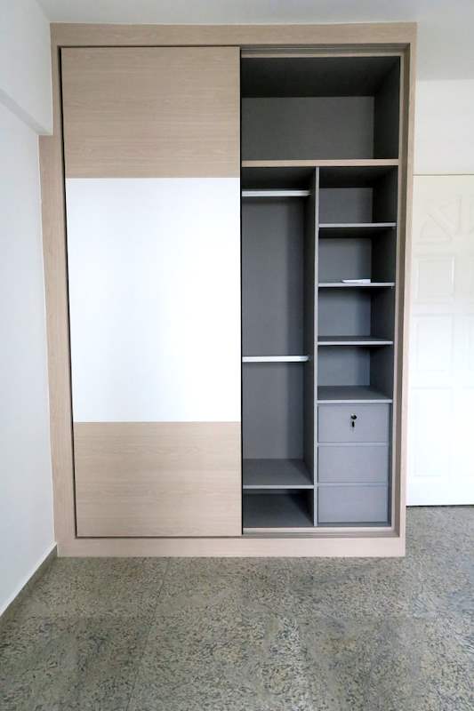 Sliding-door wardrobe half open showing grey shelving, a hanging rail and drawers - HDB resale flat renovation with polished terrazzo floors, new kitchen and bathrooms (C04) | Larry Contractors, HDB Licensed Renovation Contractor, Singapore