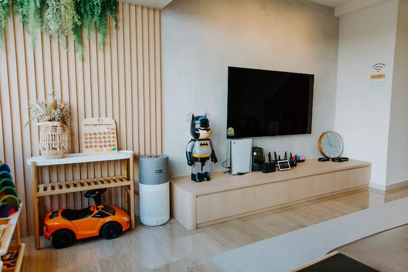 Timber-slat feature wall with hanging plants beside the floating TV console - Full HDB maisonette renovation with a curved timber-slat island and lit staircase (140BB) | Larry Contractors, HDB Licensed Renovation Contractor, Singapore