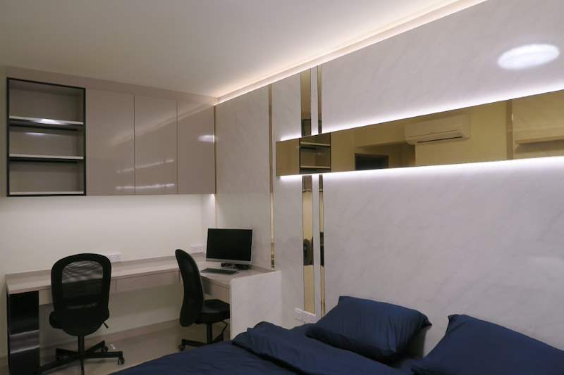 Bedroom study corner with two office chairs, a computer and overhead cabinets - HDB flat renovation in cream and mirror-trim laminate with a galley kitchen (C10) | Larry Contractors, HDB Licensed Renovation Contractor, Singapore
