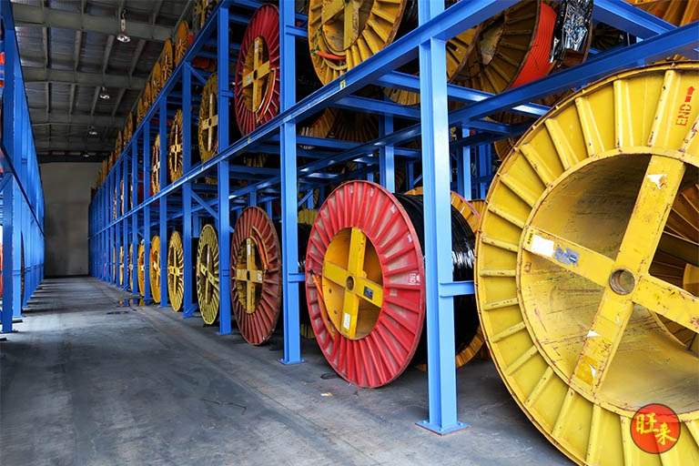 Large yellow and red cable drums in the racking bays beside the aisle - Heavy-duty cable drum racking in a cable yard (TSE) | Larry Contractors, HDB Licensed Renovation Contractor, Singapore