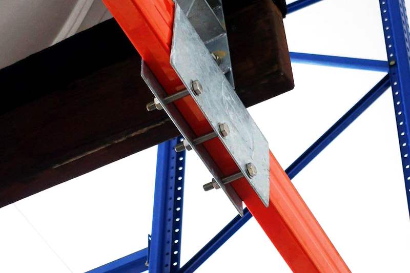 Galvanised plate bracket bolted through the timber bunk and the orange beam, seen from below - Heavy-duty storage racking for boats and jet skis (Sentosa) | Larry Contractors, HDB Licensed Renovation Contractor, Singapore