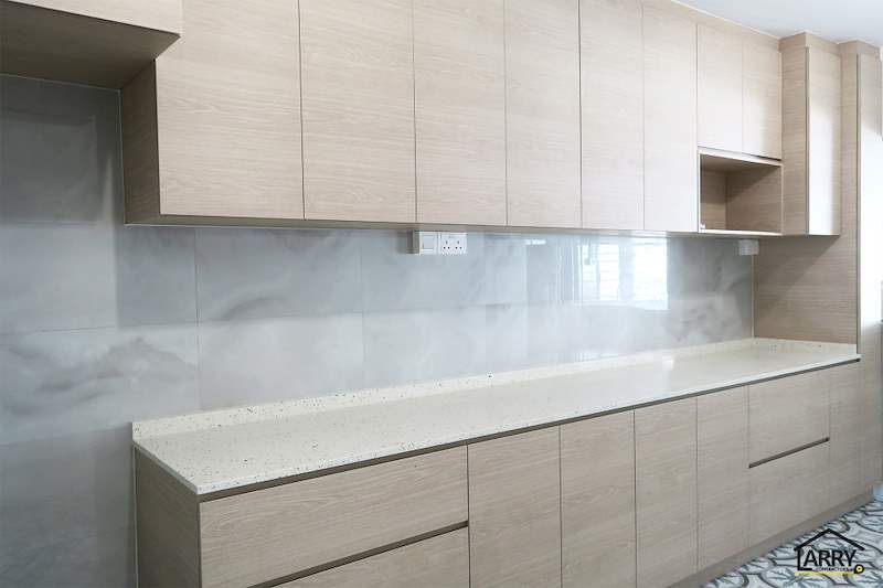 Kitchen run with light wood cabinets, a cream worktop and marble-look wall tiles - HDB resale flat renovation with polished terrazzo floors, new kitchen and bathrooms (C04) | Larry Contractors, HDB Licensed Renovation Contractor, Singapore