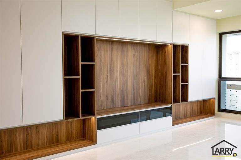 After: the walnut-look TV feature wall with white cabinets either side and a low TV console - HDB flat renovation with full-height carpentry and a wood-tone kitchen (C12) | Larry Contractors, HDB Licensed Renovation Contractor, Singapore