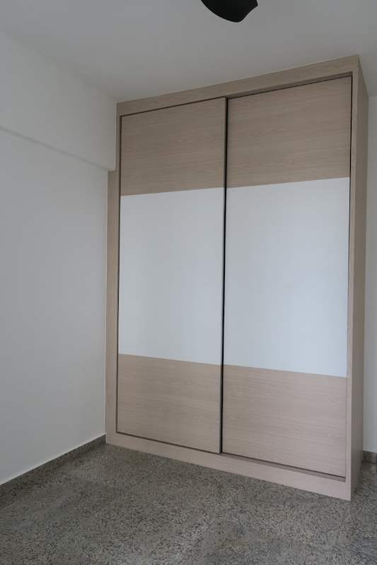 Sliding-door wardrobe in light wood and white laminate with the doors closed - HDB resale flat renovation with polished terrazzo floors, new kitchen and bathrooms (C04) | Larry Contractors, HDB Licensed Renovation Contractor, Singapore