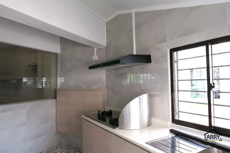 Kitchen hob under a black cooker hood with marble-look wall tiles and a grilled window - HDB resale flat renovation with polished terrazzo floors, new kitchen and bathrooms (C04) | Larry Contractors, HDB Licensed Renovation Contractor, Singapore